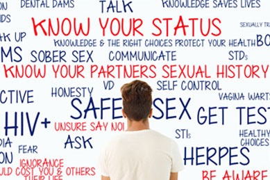 Man standing in front of a whiteboard showing HIV prevention axioms
